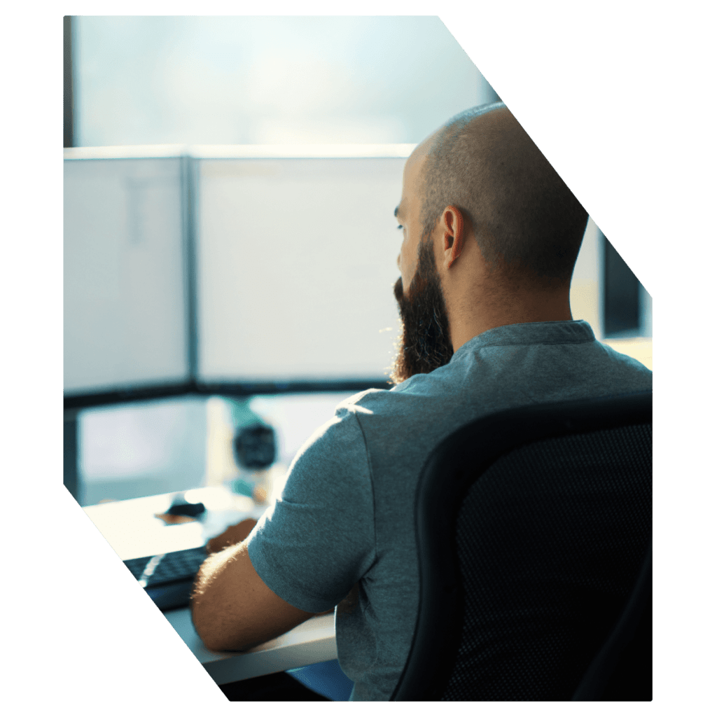 Man working on desktop computers